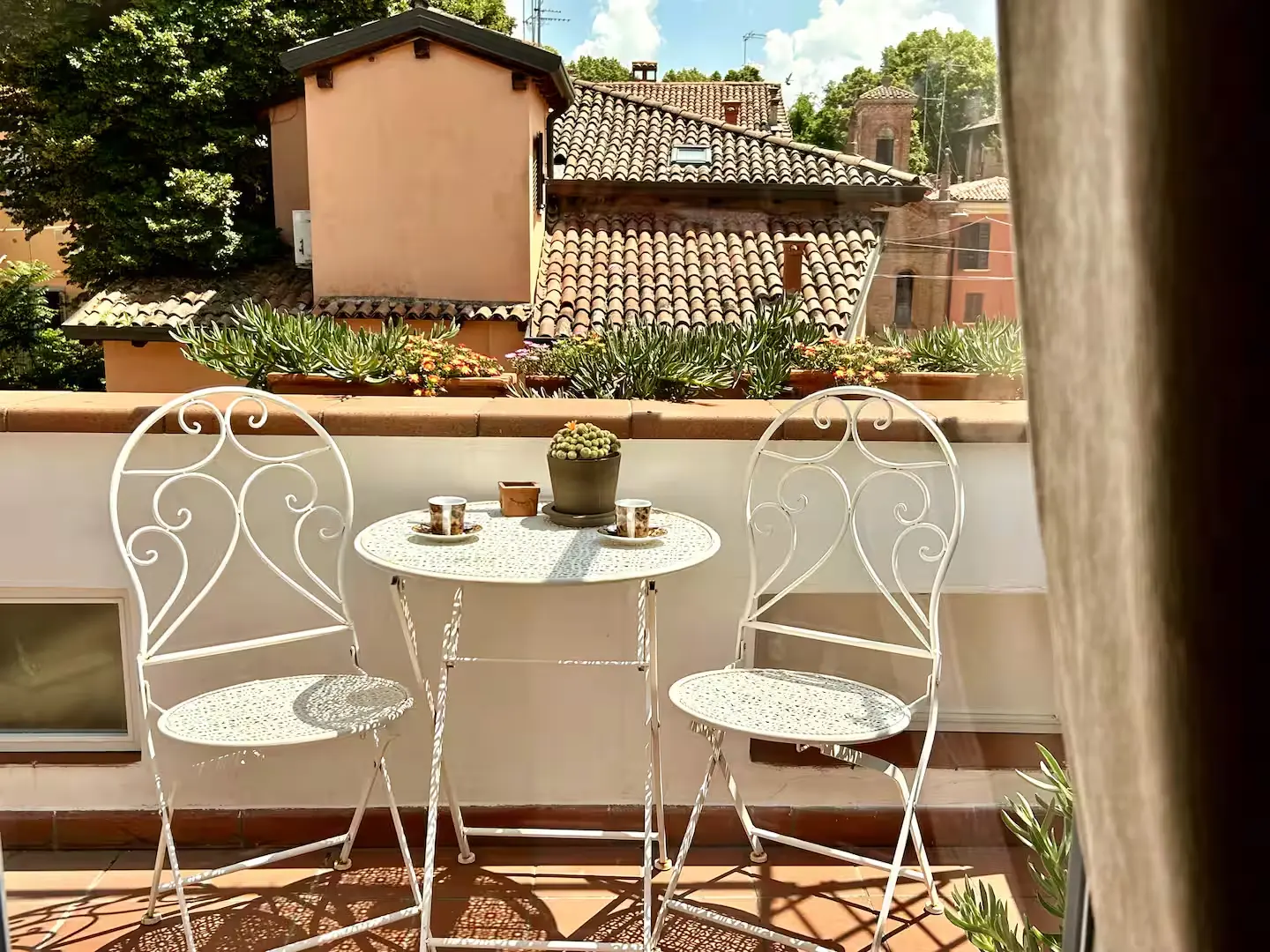 Private flower-filled terrace of Attico Castiglione over the rooftops of Bologna
